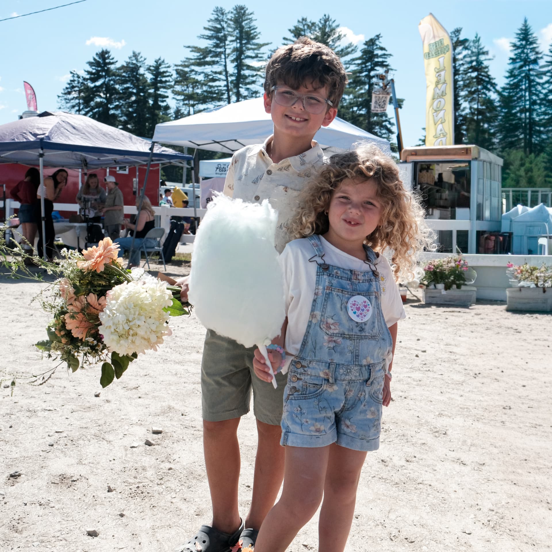 Two young guests sharing a blue cotton candy